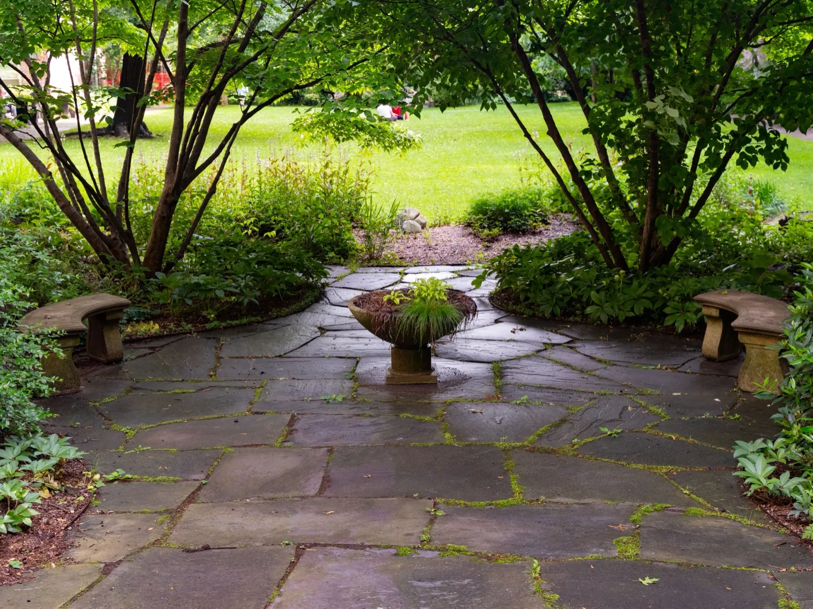 Natural flagstone patio installed in a landscaped Ladue-area backyard