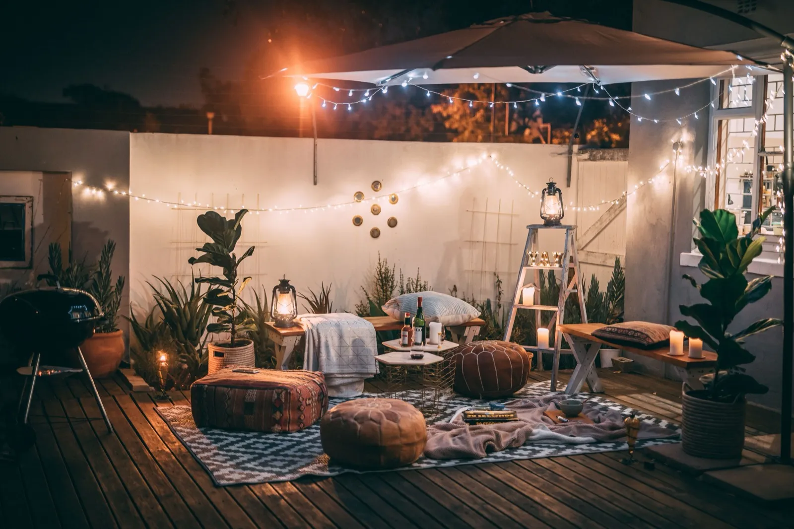 Outdoor living space with lighting for evening use across seasons